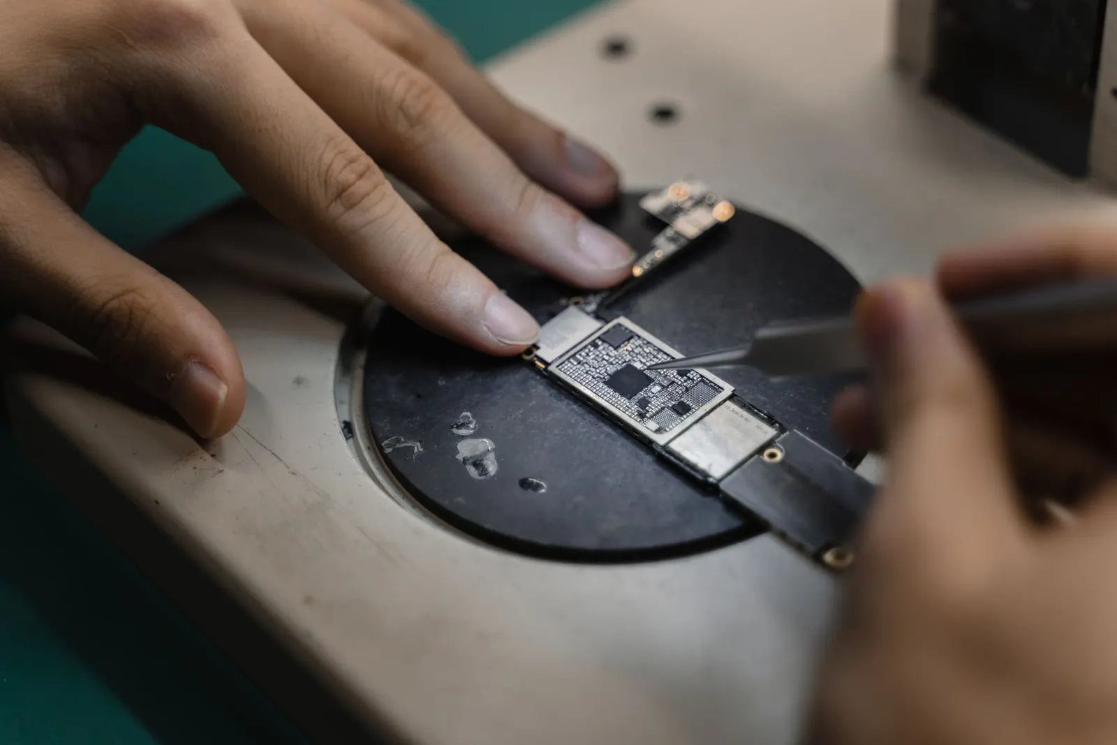 Micro-soldering on a phone motherboard