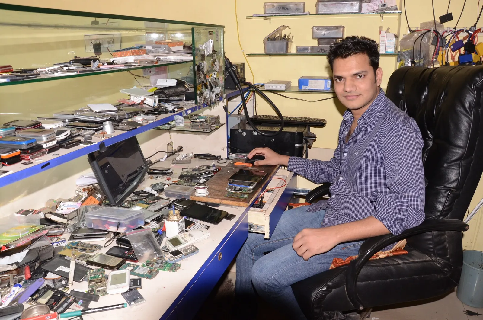 Technician at the Prince Mobile Service Center repair bench in Keshavpura, Kota