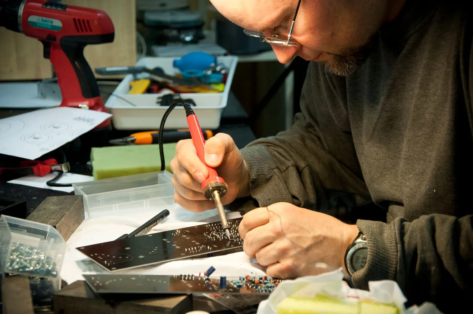 Technician soldering a circuit board